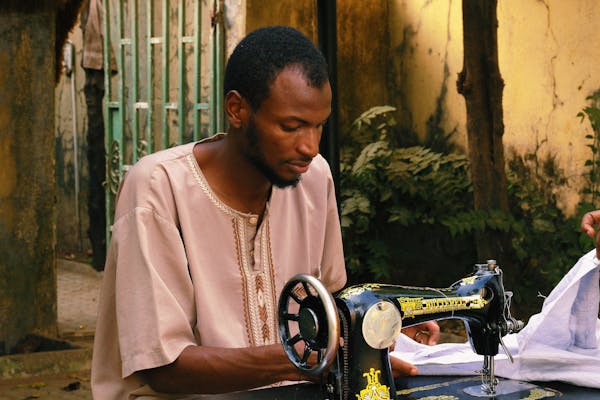 African tailor working on sewing machine