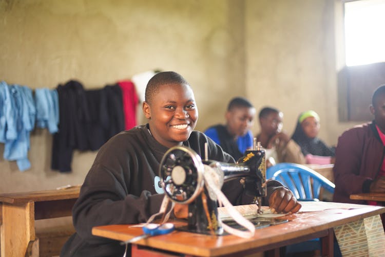 Ugandan student learning tailoring at SHUL skills centre