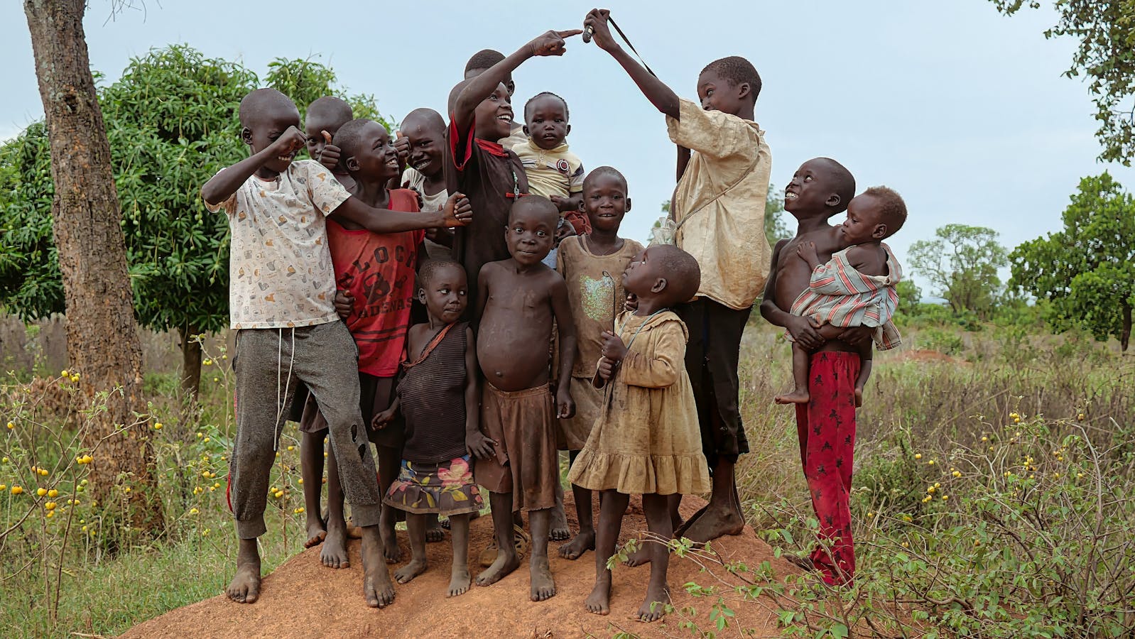 Joyful Ugandan children playing together outdoors in Rubindi