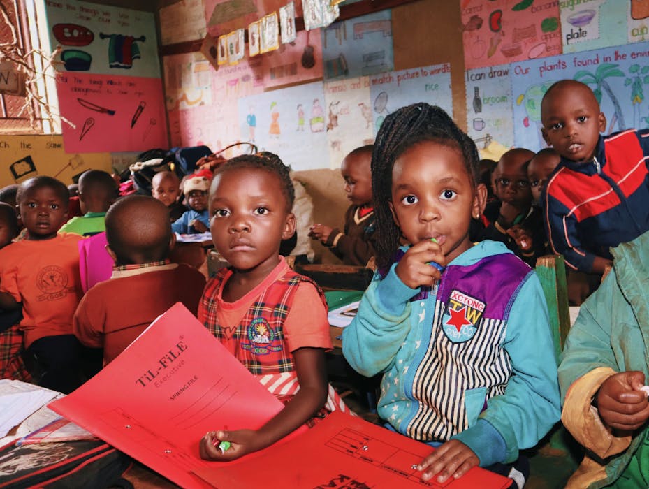 Ugandan toddlers in daycare classroom eating and learning at SHUL